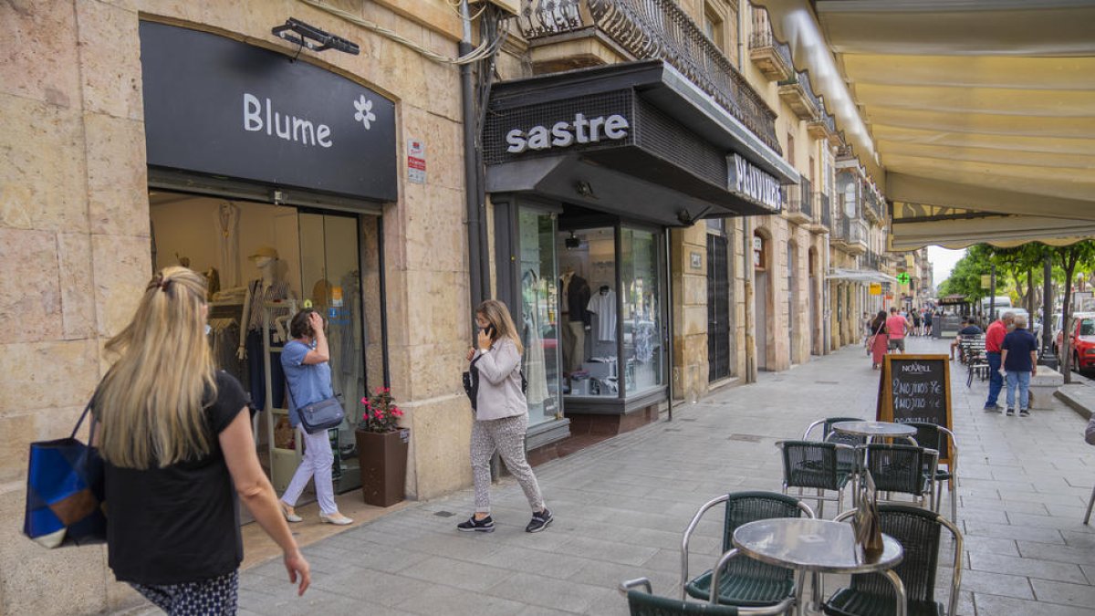 Vianants passejant ahir a la tarda per la Rambla Nova de Tarragona, entrant i sortint de botigues.