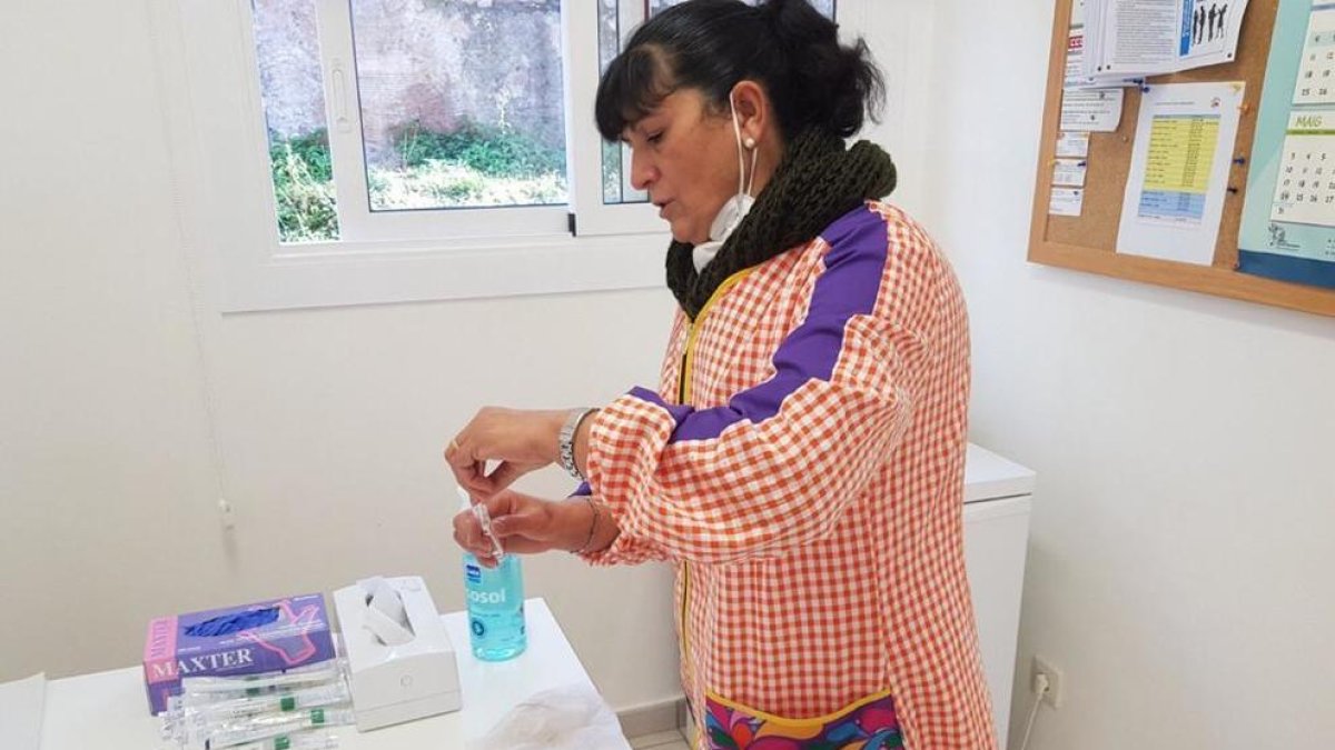 Una docente del Jardín de Infancia Sant Ramon Nonat de Girona prepara el material para tomarse una muestra de tejido por frotis nasal.