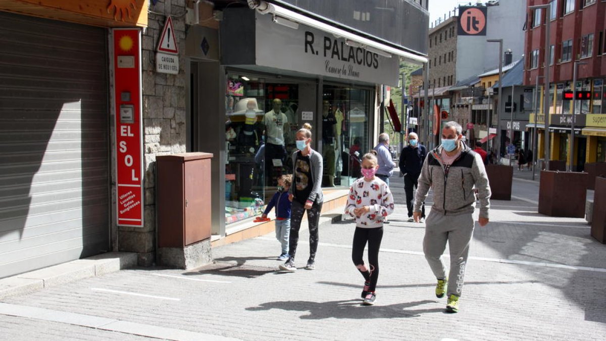 Un grupo de personas paseando para|por una de las calles comerciales del Paso de la Casa.