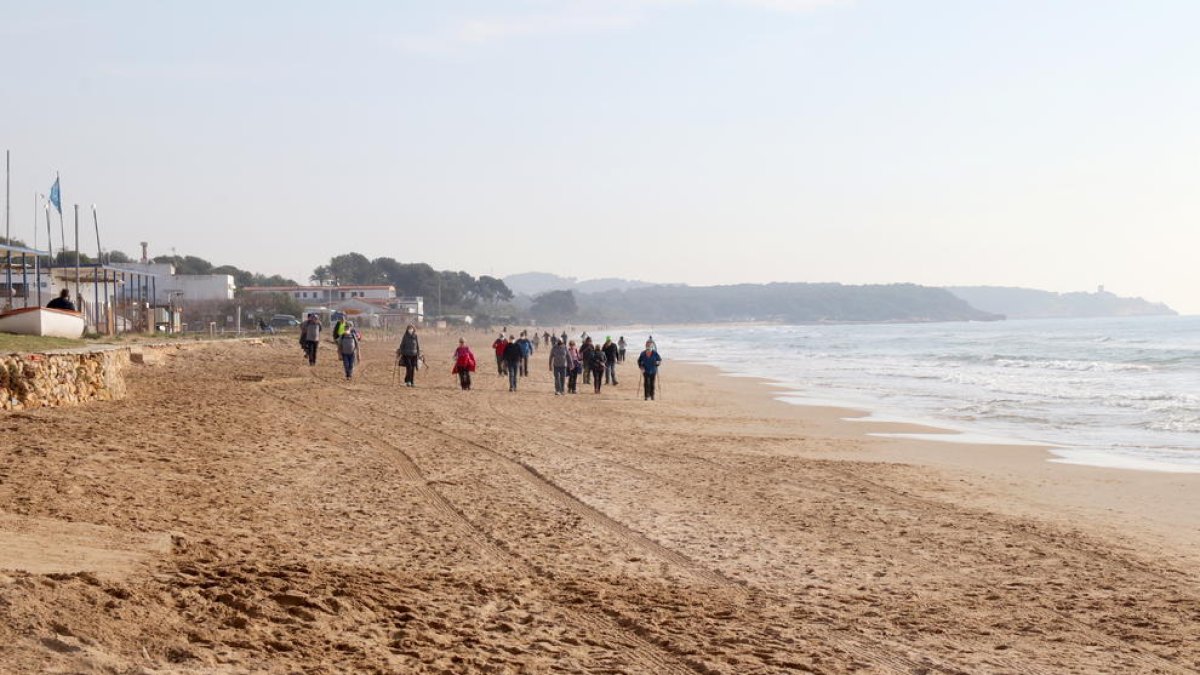 Pla general de la platja Llarga de Tarragona, amb persones passejant.