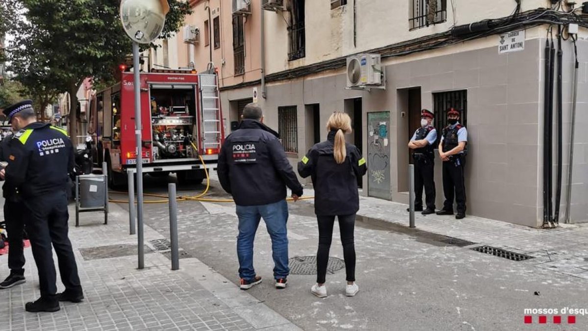 Efectius de diferents cossos de seguretat davant d'un camió de Bombers durant l'incendi en un pis de l'Hospitalet de Llobregat.