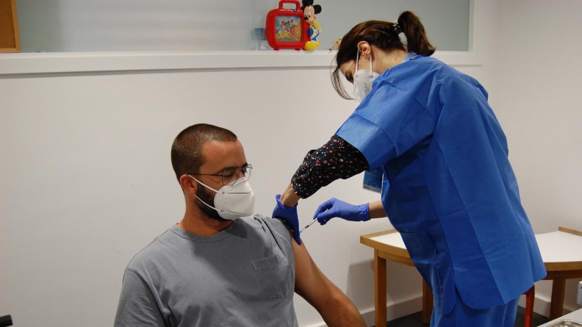 Sanitaris injectant la segona dosi de la vacuna de la covid-19, en una imatge d'arxiu.