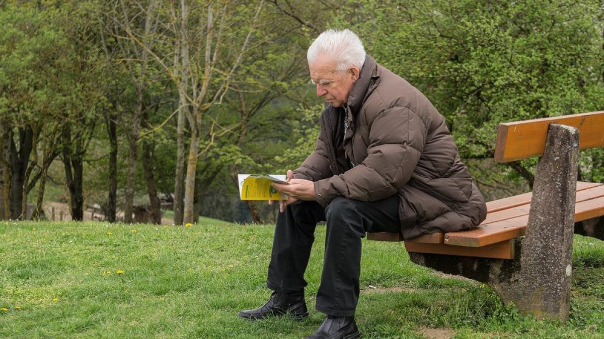 Imagen de archivo de un hombre leyendo un libro.