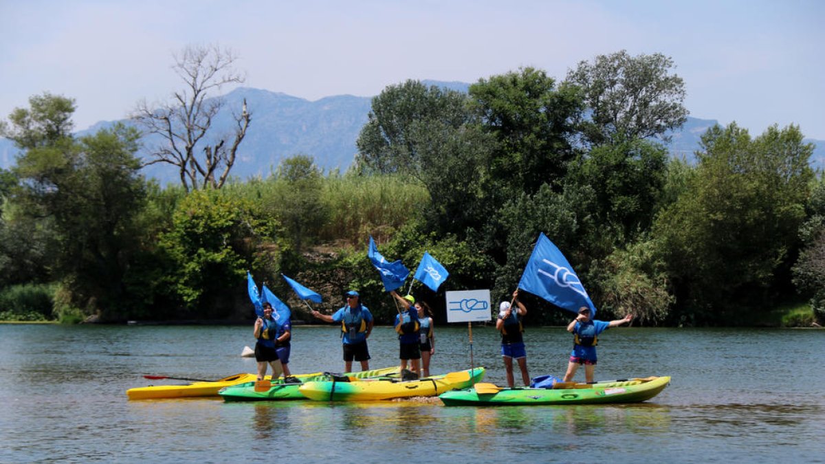 La PDE fent onejar els banderes antitransvasament a una illa del riu Ebre, en l'acció sorpresa del final de la 20a Piraguada en Defensa de l'Ebre.