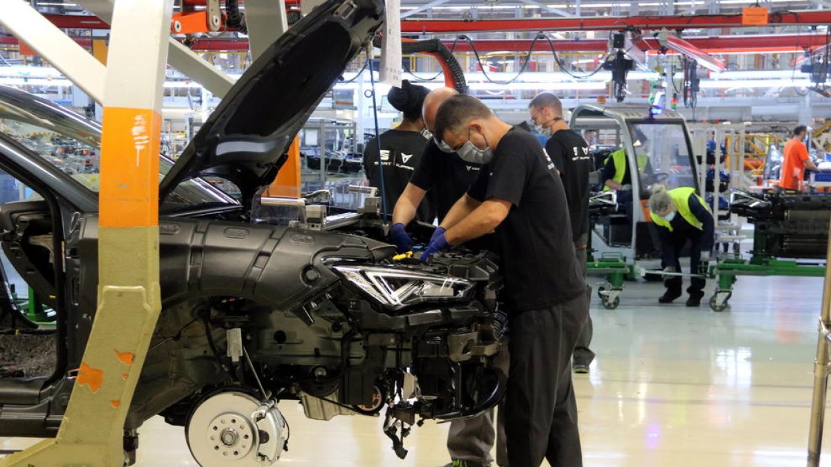 Dos operarios de la cadena de producción de la planta Seat de Martorell.