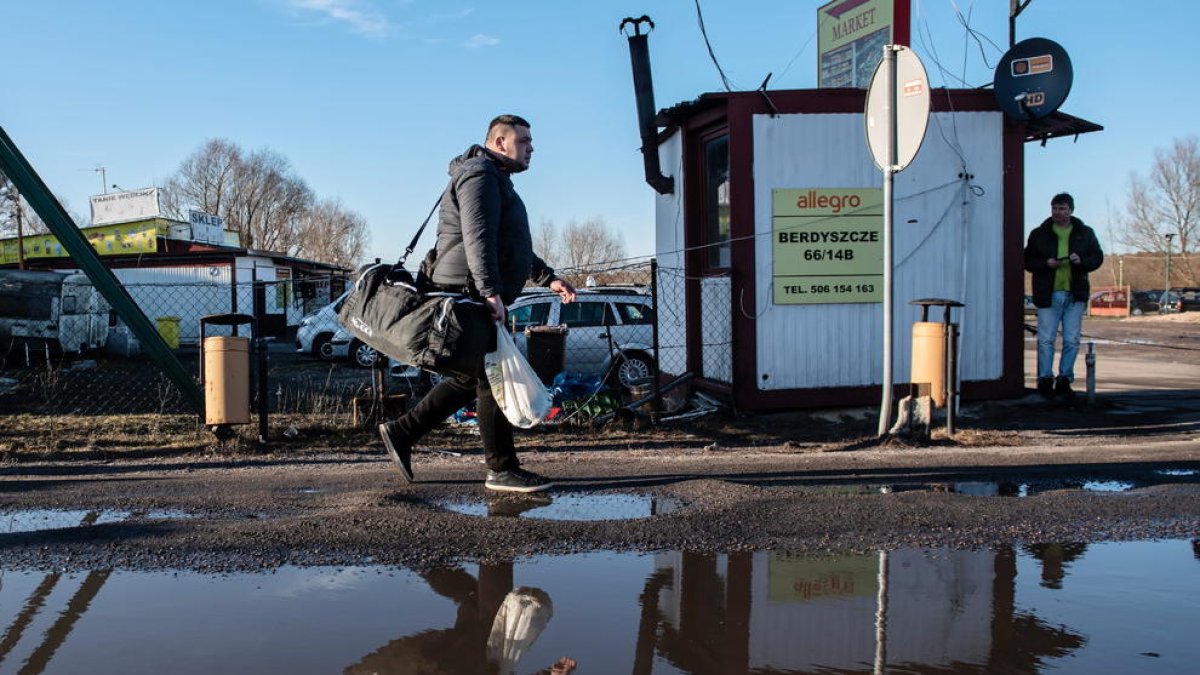 Un hombre atravesando la frontera entre Polonia y Ucrania.