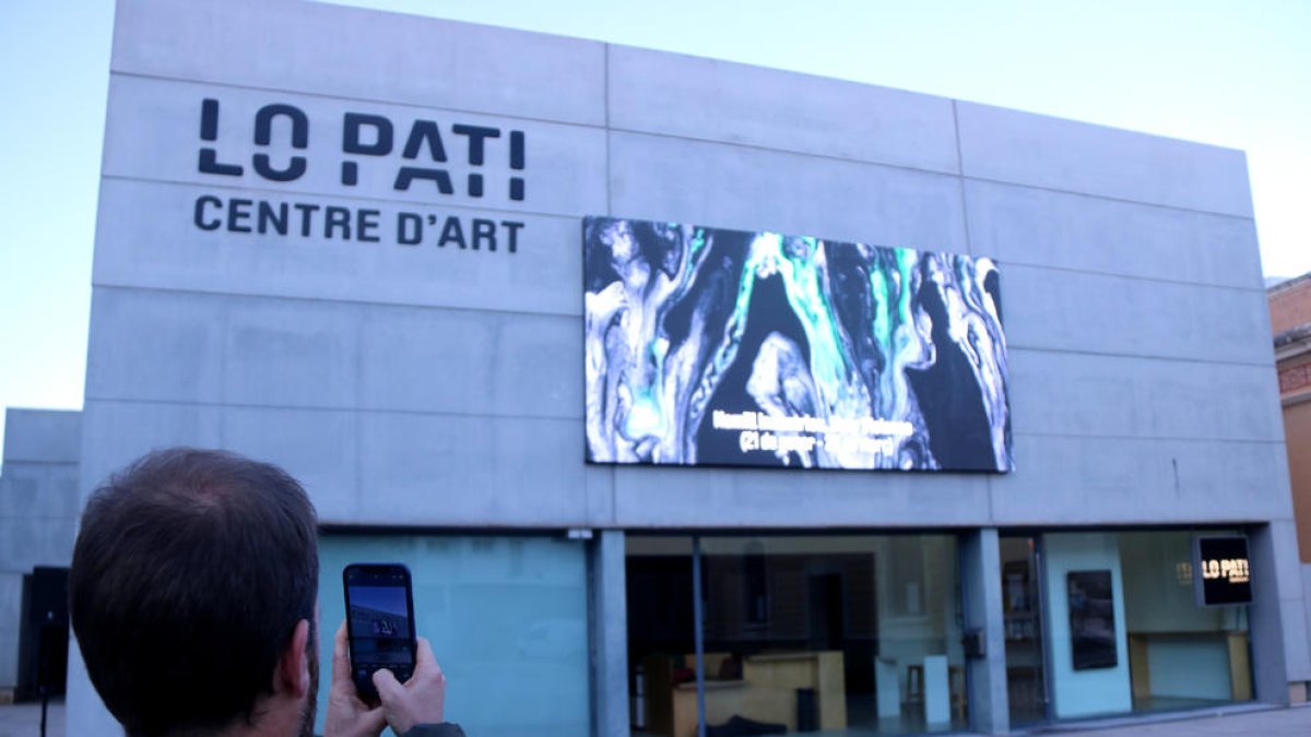 Un dels artistes de 'Miratges' fotografia la nova 'sala expositiva' la Façana de lo Pati.