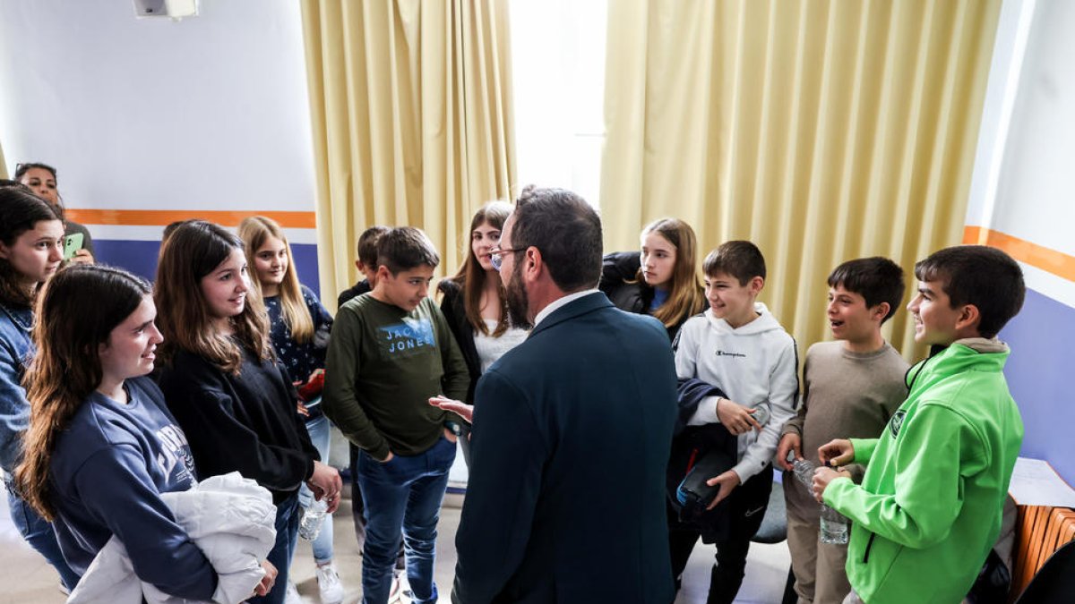 El conseller Juli Fernàndez conversant amb alumnes de l'institut escola del Perelló.