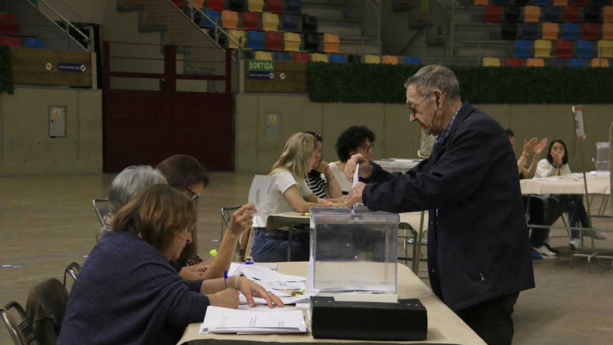 Un hombre votando en el colegio electoral de la Tarraco Arena de Tarragona.