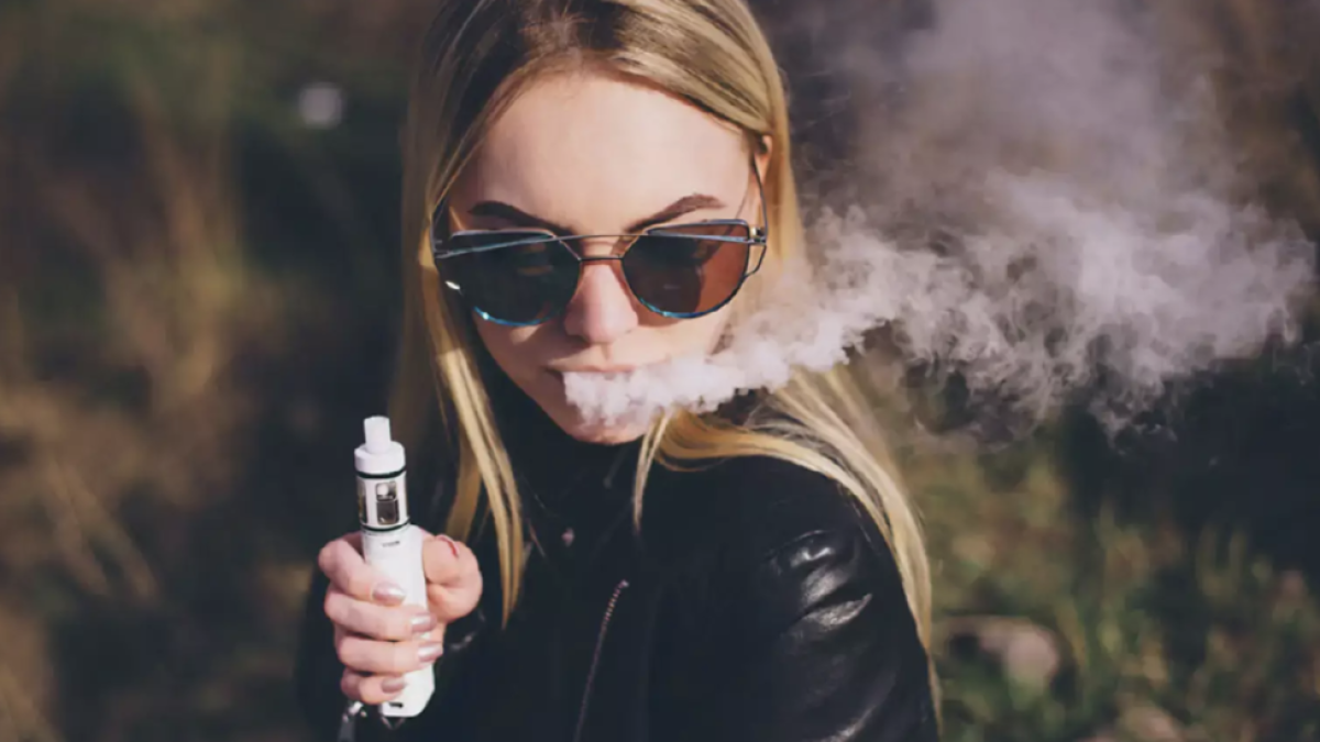 Imatge d'una jove amb una cigarreta electrònica.
