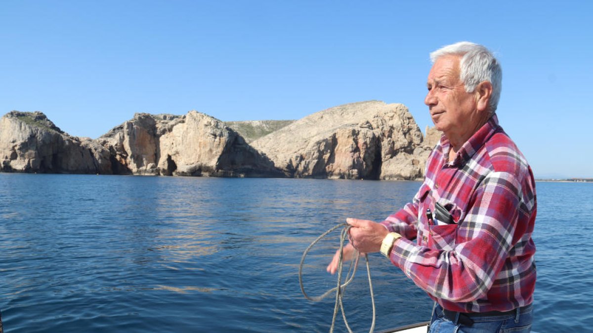 El meteoròelg Josep Pascual recull la corda d'una sonda que utilitza per mesurar la temperatura de l'aigua amb les illes Medes de fons.