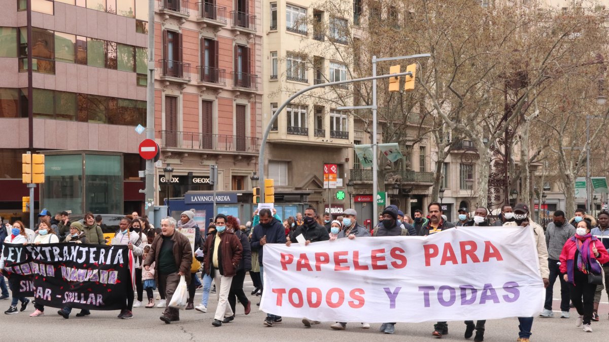 Diversos manifestants amb una pancarta que reclama papers per a tothom.