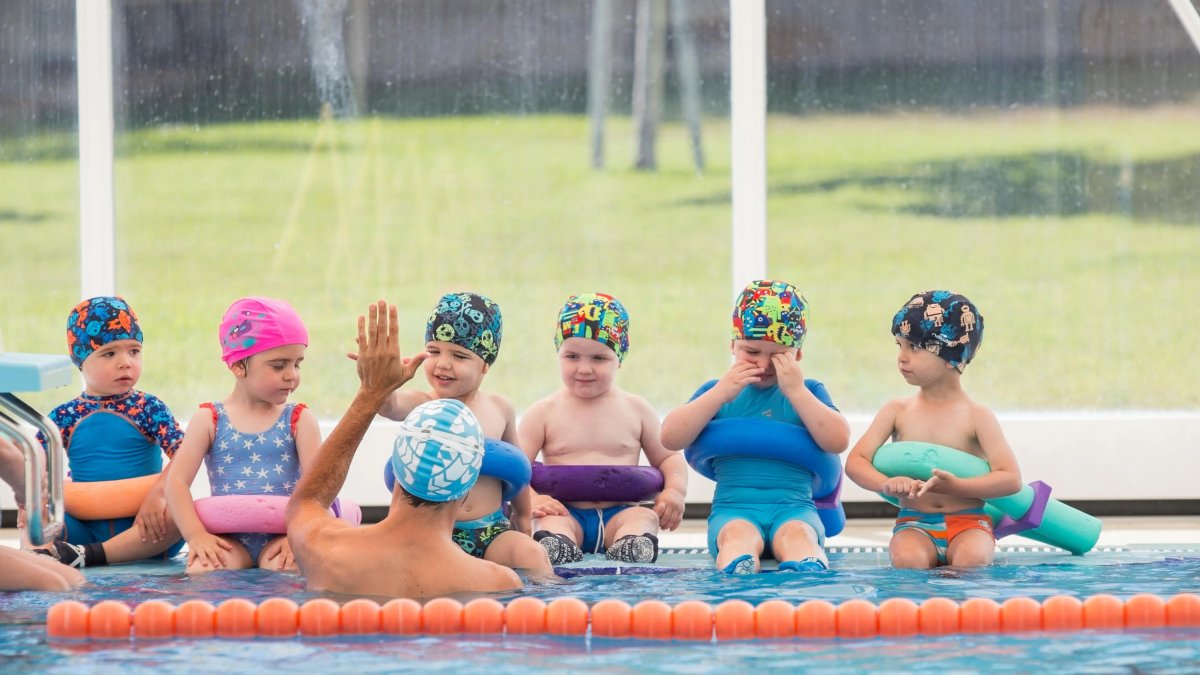 Diversos nens en una piscina.