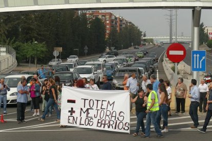 Els manifestants, amb els cotxes aturats de fons.