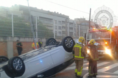 El cotxe va quedar totalment bolcat al mig del carrer.