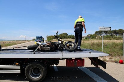 Un operari de la grua retira la moto sinistrada en un accident mortal a l'entrada a Nulles (Alt Camp).