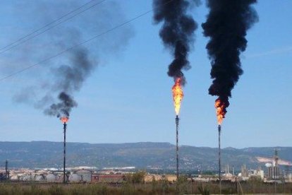 Las dos antorchas de Repsol i Dow a la izquierda con las densas columnas de humo negro visibles a muchos kilómetros, en el polígono Norte, el pasado 23 de mayo de 2016.