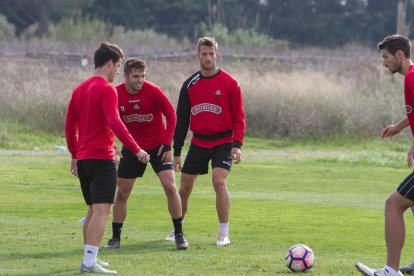 Los rojinegros Fran Carbia y Máyor, en un entrenamiento de esta temporada, con el atacante portugués del CF Reus Ricardo Vaz.