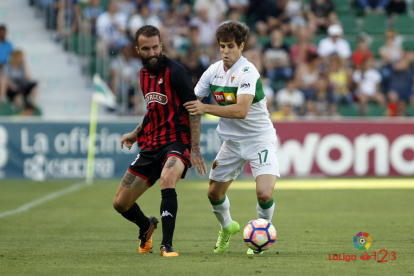 Ángel lluita per una pilota amb un rival.