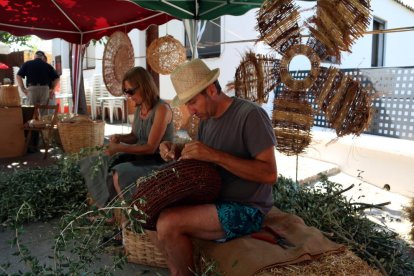 Dos expositors treballant en la Fira de les Fibres Vegetals de Mas de Barberans.