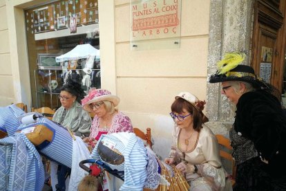 Mujeres vestidas de época mostraban el arte de los bolillos mientras los visitantes paseaban por la feria.