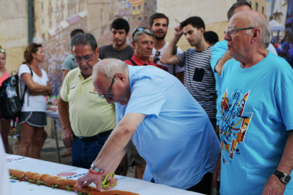 Eduard cortando el bocadillo con unas tijeras, como siempre ha hecho en Can Boada.