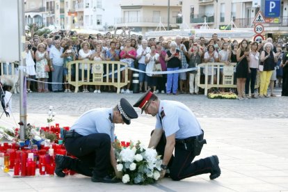 Imagen de archivo de un mosso d'esquadra y un agente de la Policía Local de Cambrils haciendo una ofrenda floral.