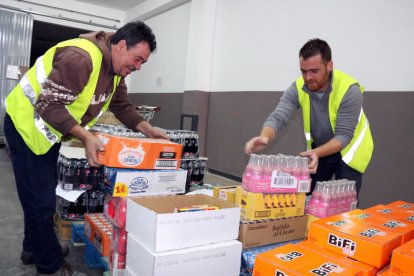 Voluntaris a la seu del Banc dels Aliments al Camp de Tarragona, ubicada a Reus, classificant aliments.