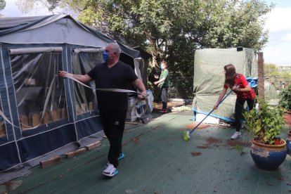 Plano medio de una de las familias que el primer día ya ha ido al camping Trillas de Tamarit para limpiar y poner a punto la caravana.