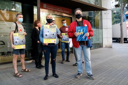 Marta Minguella, delegada de CGT Ensenyament, i Xavier Massó, secretari general de Professors de Secundària, mostren un cartell amb la convocatòria de vaga.