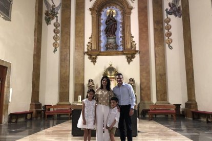 Jorge Orts y Laura Romera, con su hija Carla después de recibir la primera comunión en la parroquia de Sant Francesc de Tarragona.