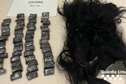 Diversos embolcalls de cocaïna al costat d'una perruca.