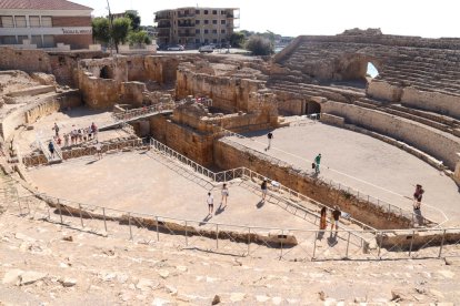 Plano general del anfiteatro de Tarragona, con visitantes paseando por la arena el primer día de la reapertura del monumento.