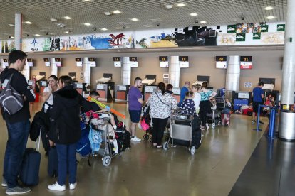 Imatge d'arxiu de l'aeroport de Reus amb persones a la cua de facturació.