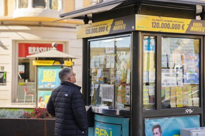 Una persona mirant els cupons d'un punt de venda de l'ONCE, situat al centre de Tarragona.