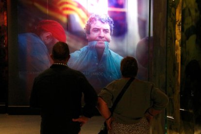 Dos visitants observant un audiovisual del nou Museu Casteller de Catalunya a Valls.