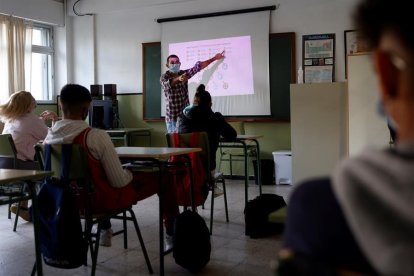 Los alumnos atienden las explicaciones del profesor en un aula.