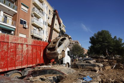 Un camión grúa recoge vehículos en Paiporta.