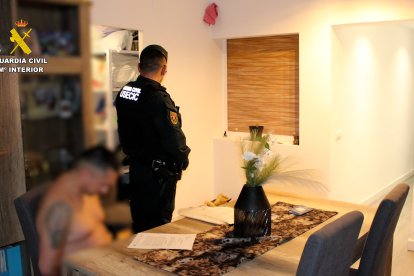 Imagen de un agente de la GC con el detenido en el piso de este en La Canonja.