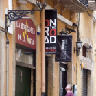 Un jove busca informació sobre pisos turístics al carrer la Nau.