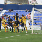 El porter del CF Reus, Edgar Badia, salta en una acció a pilota aturada per mirar de refusat el tret d'un oponent de l'UCAM Murcia.