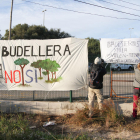 Uns veïns van penjar una pancarta en contra del Pla Parcial Urbanístic de la Budellera, abans de fer una marxa reivindicativa.