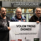 Carlos Montejano, José Tabuyo y Daniel Pi sostienen una pancarta pidiendo «trenes dignos».