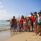 Fotografia família dels nens del casal d'estiu amb els monitors de Creu Roja, ahir, a la platja del Miracle.