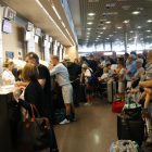 Plan|Plano general de largas colas de pasajeros para facturar en el Aeropuerto de Reus en relación a la quiebra|bancarrota de la compañía Thomas Cook. Imagen del 24 de septiembre del 2019