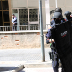 Agents ARRO dels Mossos d'Esquadra sortint del portal d'un bloc de pisos de Valls.