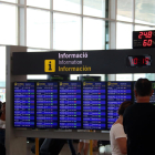 Plano medio de un panel informativo de vuelos de salida al aeropuerto del Prat, con ningún vuelo cancelado.