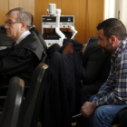 Pla tancat dels dos acusats, a la dreta i un d'ells tapant-se amb una jaqueta, a l'Audiència de Tarragona.
