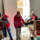 Voluntarios de Cruz Roja de Amposta preparando cajas con productos alimenticios y de higienees para repartir entre las familias más vulnerables de la ciudad.
