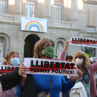 Una dona subjecta una pancarta amb el lema 'Llibertat presos polítics' a la plaça Sant Jaume de Barcelona.